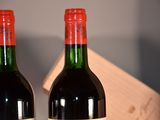 two bottles of wine sitting next to each other on a table