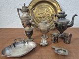 a lot of silver items sitting on a table