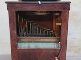 a wooden cabinet with a musical instrument inside of it