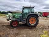a tractor that is parked in the dirt