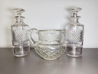 three glass vases sitting on a table next to each other