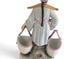 a figurine of a woman holding two buckets