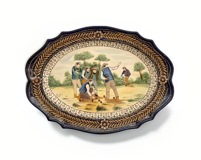 HENRIOT à Quimper Plat ovale en faïence à bords chantournés,…