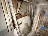 une photo d'une pièce avec une échelle et une fenêtre