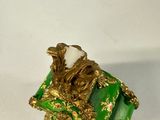 a green box with a gold decoration on it