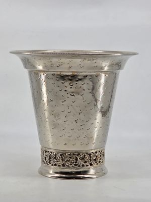 a silver cup that is sitting on a table