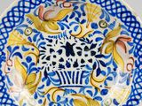 a blue and white plate with a floral design on it