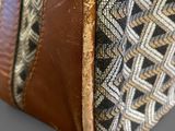 the inside of a brown and black bag with a pattern on it