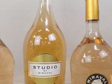 three bottles of wine sit on a table next to each other