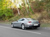 a silver sports car driving down the road