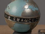 a metal object with a globe on top of it