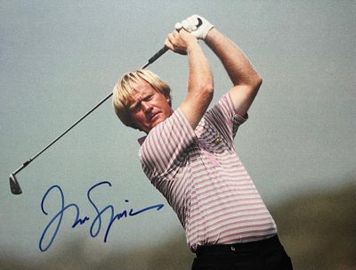 signed photo of a man swinging a golf club on a cloudy day