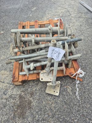 a pile of screws and bolts on a pallet on the ground