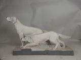 a statue of a dog and a cat on a table