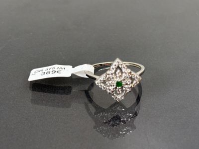 a close up of a diamond ring on a table with a price tag