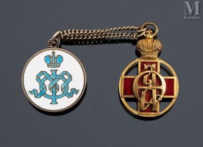two medals that are on a chain on a table