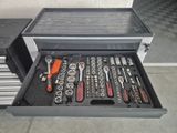 many tools in a tool box on the floor