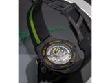the watch is black with a green band around the strap