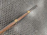 a gun that is laying on top of a piece of metal