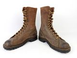 an old pair of brown boots with laces on them on a white background