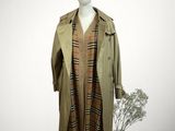 an image of a mannequin dressed in a trench coat and hat