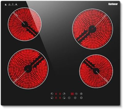 a black and red stove top with four burners on it