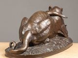 bronze statue of a bull and a ram on a wooden surface