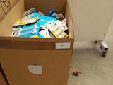 a cardboard box full of food sitting on the floor