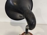 an old fashioned black phonom on a wooden stand
