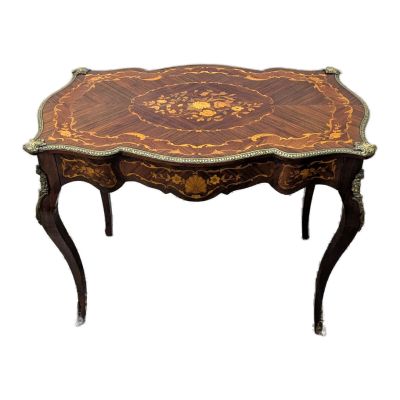 an image of a small table with a wooden top and ornate decoration