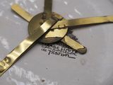 a close up of a clock on a white plate