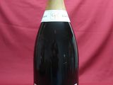 bottle of sparkling wine on a red background with a pink backdrop
