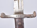 a knife that is sitting on top of a wooden pole