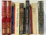 a lot of books that are lined up on a shelf