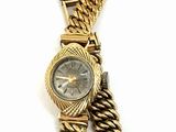 an image of a gold watch with a chain around it