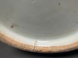 a white plate with a brown rim sitting on a table