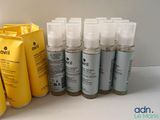many bottles of hair care products sitting on a table