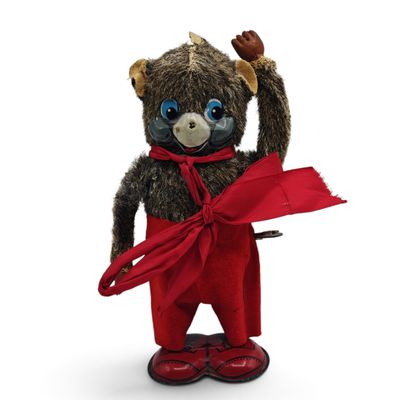 a teddy bear that is dressed in red pants and a red scarf