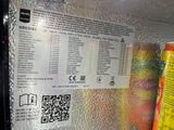 a can of soda and a can of orange juice in a refrigerator