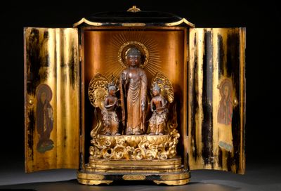 a golden statue of a buddha in a gold case