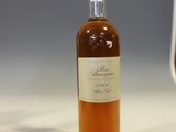 a bottle of whiskey sitting on a counter next to a glass