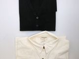 a white shirt and a black shirt sitting next to each other