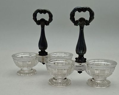 three glass bowls and a bottle opener on a white surface