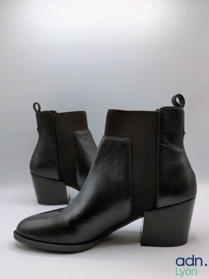 a close up of a pair of black boots on a white background