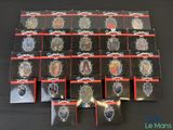 lot of 12 badges in plastic bags on a black table