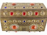 a gold box with red, blue, and orange stones on it