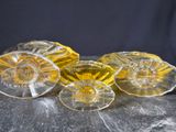 three yellow glass knobs sitting on top of a black surface