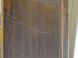 a wooden screen with a mirror on top of it