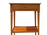 a small wooden table with a drawer on it