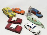 several toy cars are lined up in a row on a white surface